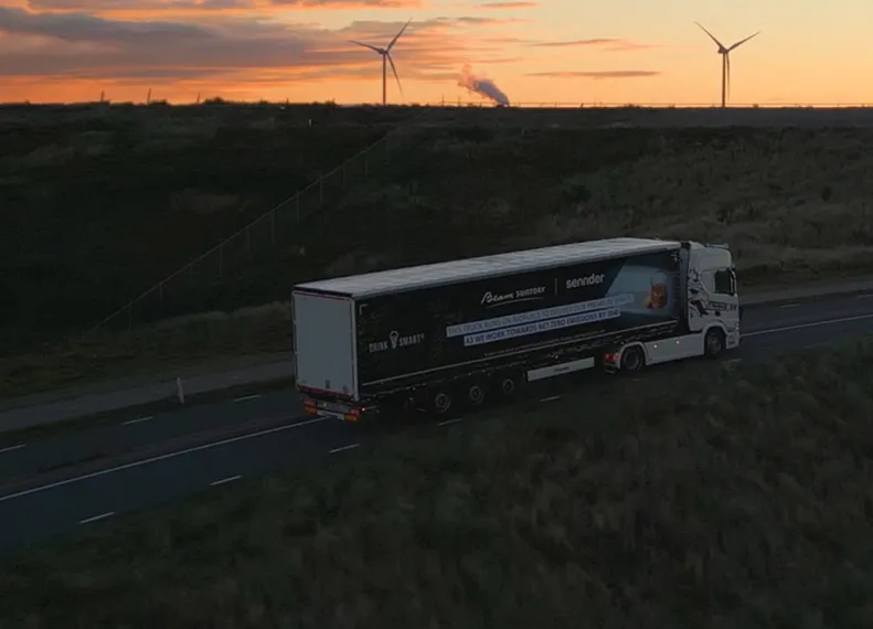 18 wheeler driving down highway into sunset