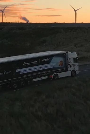 18 wheeler driving down highway into sunset