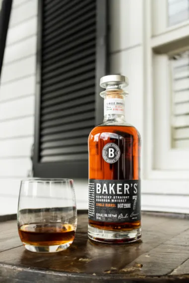 A bottle and a glass of Baker's Bourbon whiskey