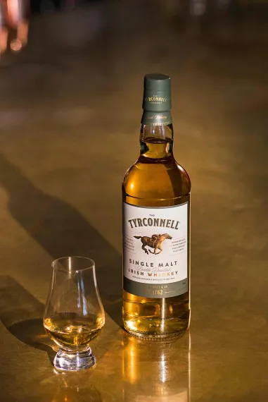A bottle and a glass of Tyrconnell Irish whiskey