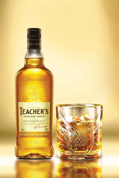 Teacher's Highland Cream bottle and glass filled with scotch