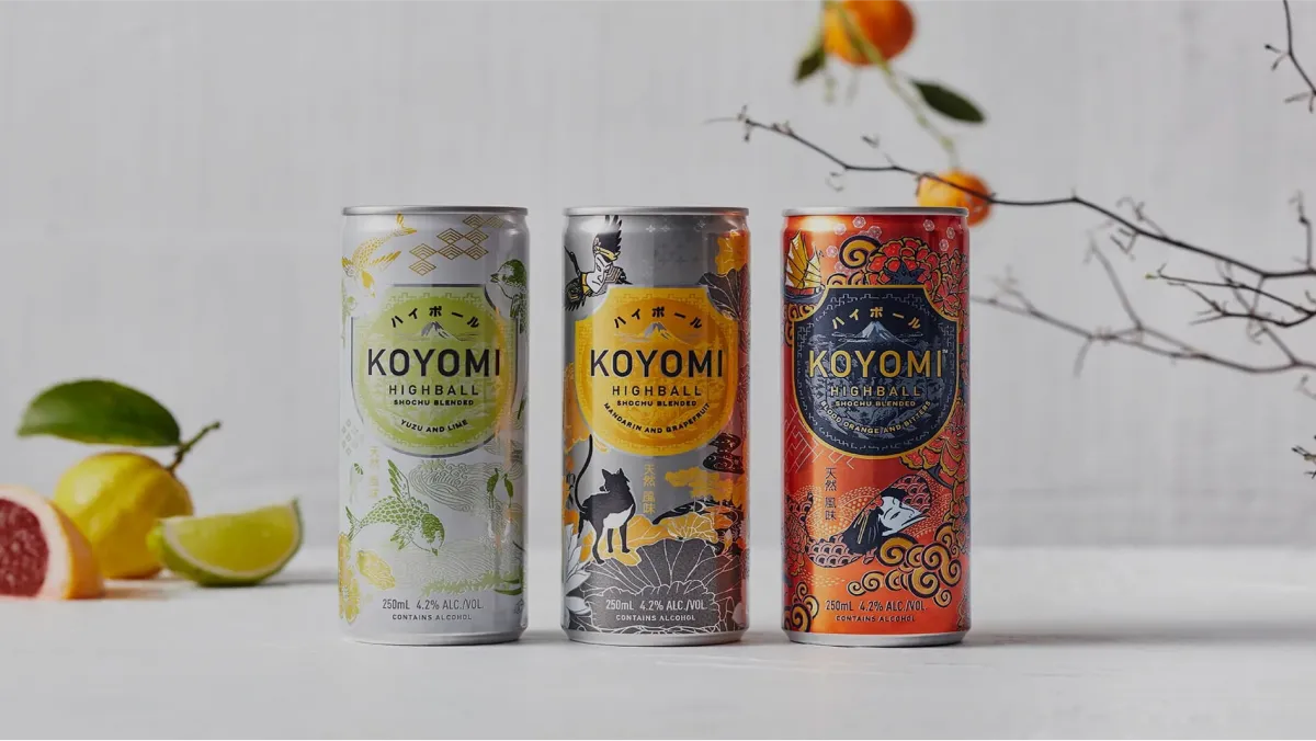 image of three Koyomi Highball cans with oranges placed in background