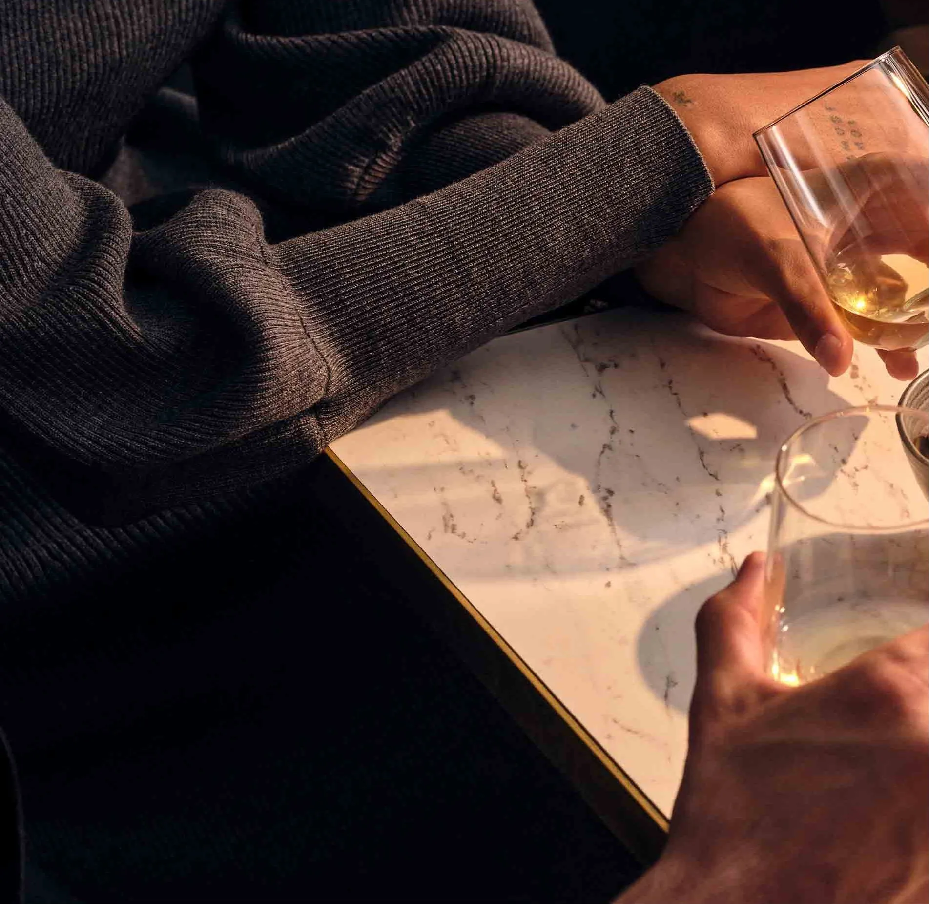 Four-people-holding-glasses-table-olives-plate-cold-meats