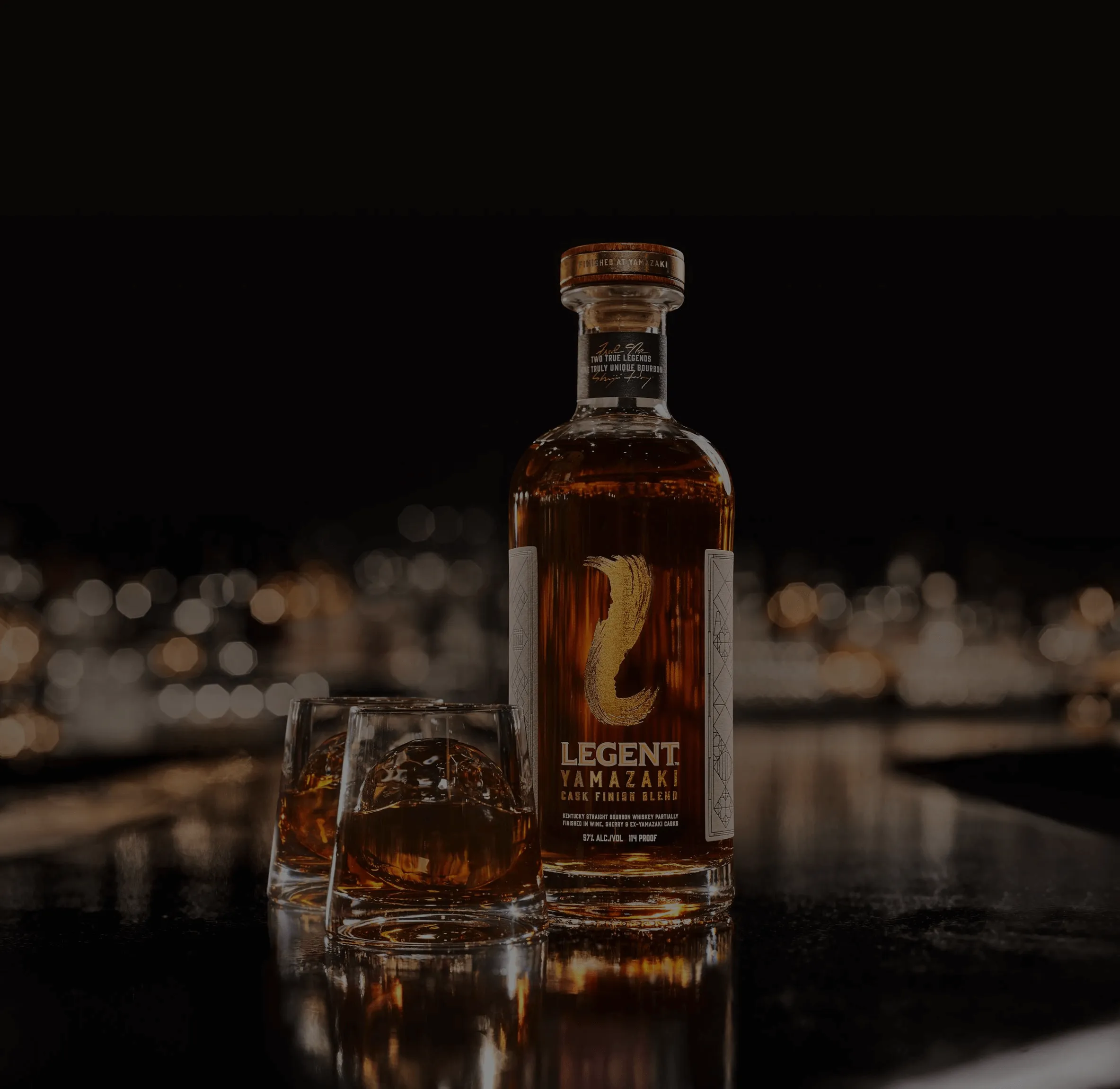 A bottle and two glasses of Legent bourbon whiskey